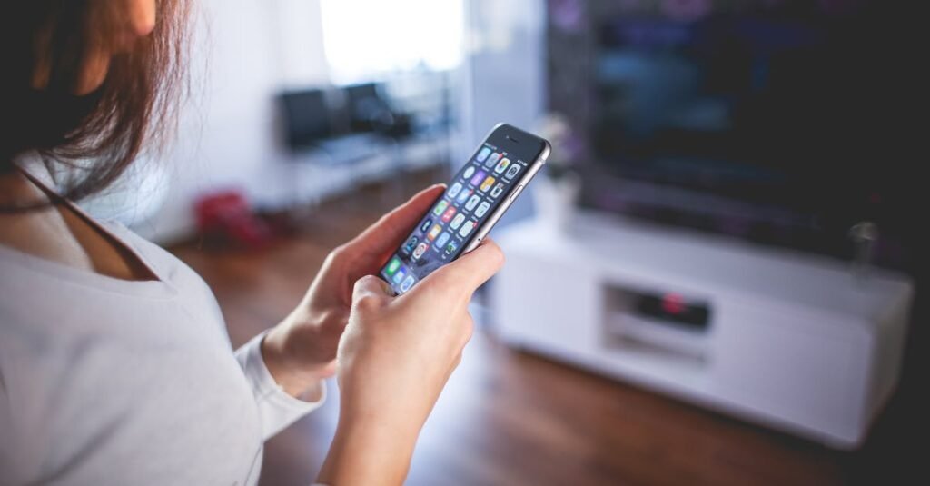 Woman browsing smartphone indoors, highlighting modern technology and communication in a cozy home setting.